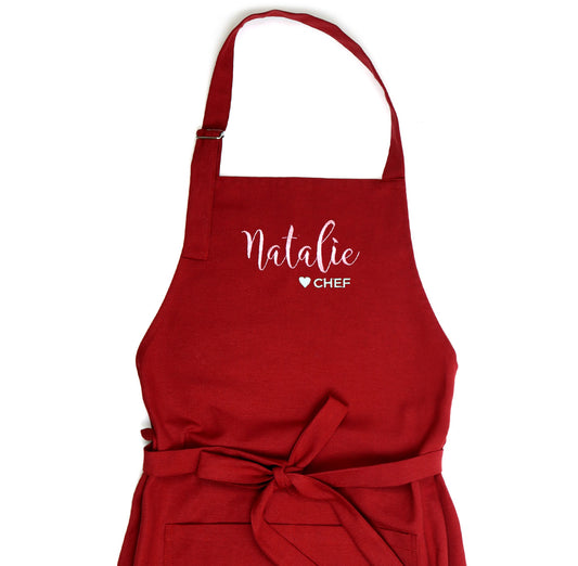 Matching red kids aprons with embroidered names – family baking gift idea