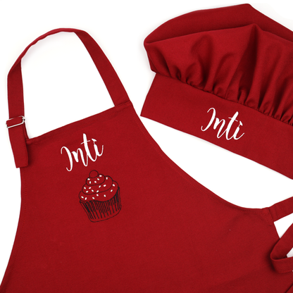 Personalized dark red apron embroidered with the name "Inti" above a cupcake design