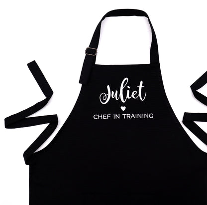 Personalized black apron for boys with embroidered name and 'Chef in Training' design"