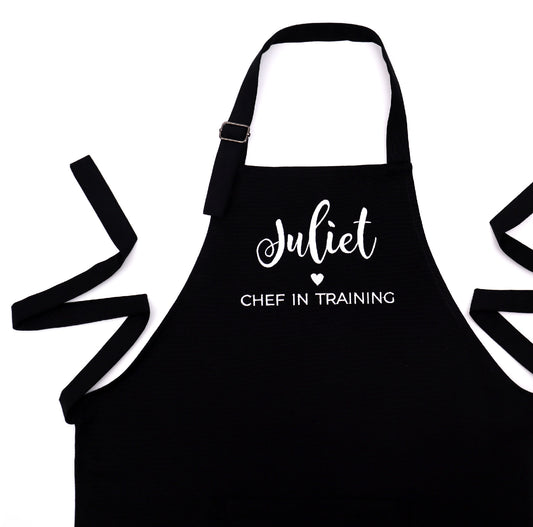Personalized black apron for boys with embroidered name and 'Chef in Training' design"