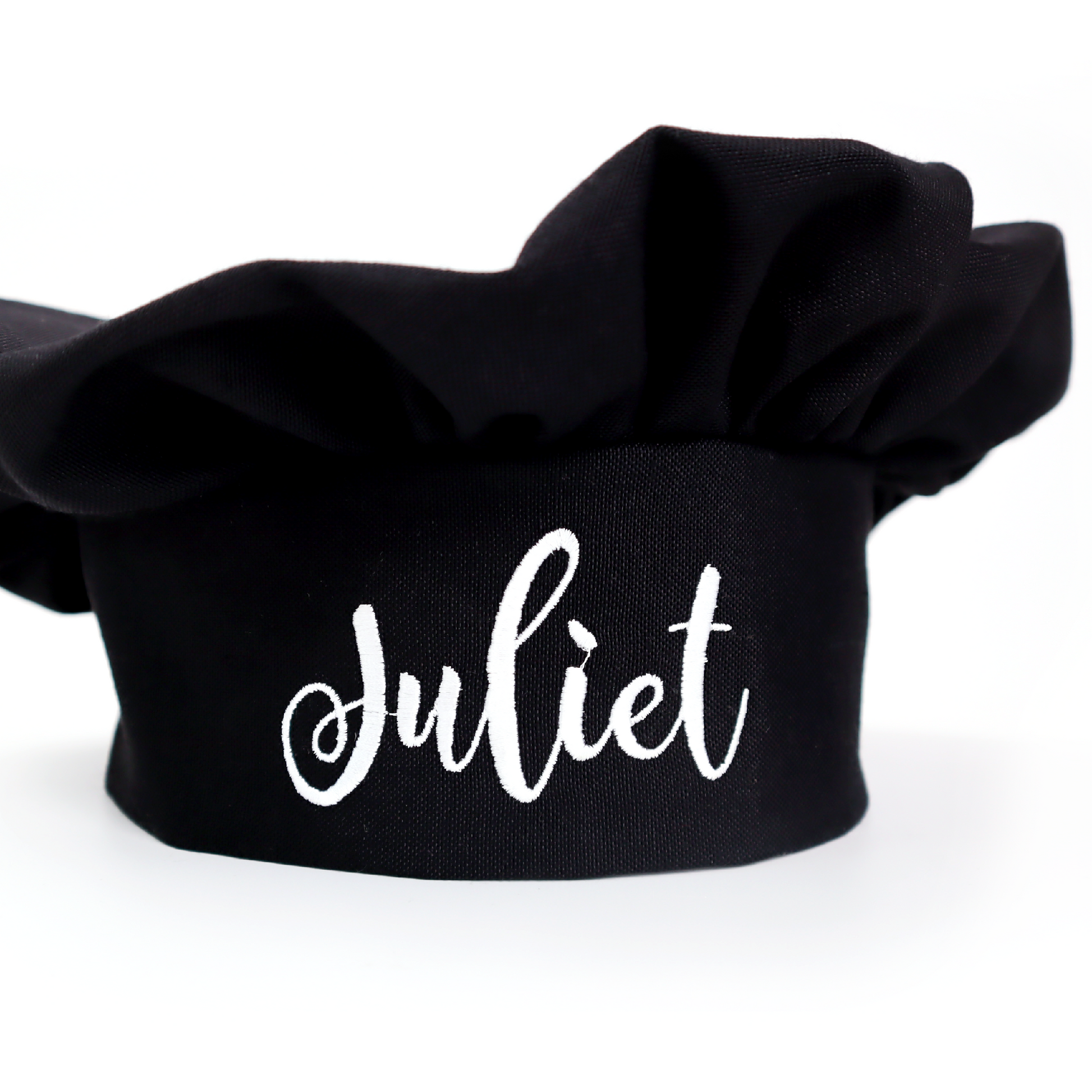 A black fabric chef hat with the name 'Juliet' printed in white cursive script on the front, set against a plain white background.