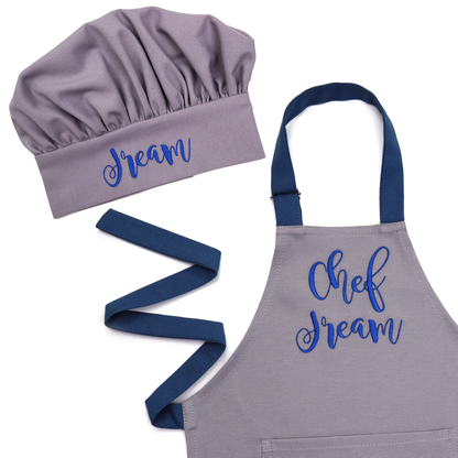 Personalized grey apron and chef hat set with navy straps, embroidered "Chef Dream"