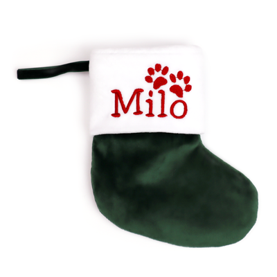 Forest green velvet Christmas stocking embroidered with the name Milo and paw prints