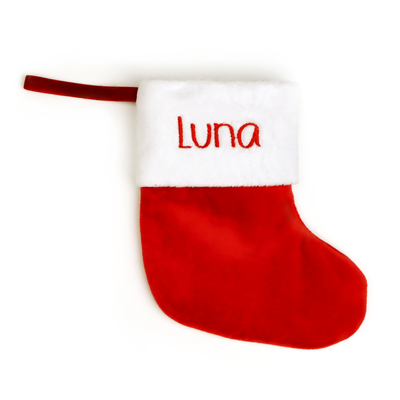 Red velvet Christmas stocking embroidered with the name Luna, on a white background
