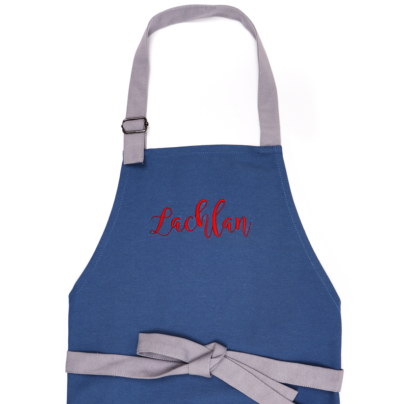 Navy blue personalized toddler apron — a sophisticated gift option