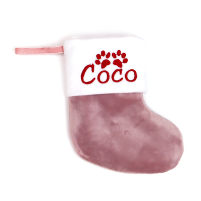 Dusty rose velvet Christmas stocking embroidered with the name Coco, on a white background