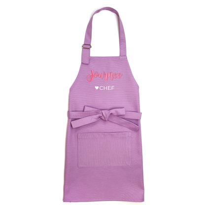 Personalized lavender apron on a white background, tied bow, embroidered "Journee ♥ Chef"