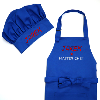Personalized royal blue apron and chef hat set, embroidered "Jarek ★ Master Chef" in red and white, on a white background