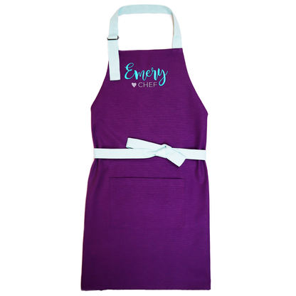 Personalized purple apron and chef hat set with mint straps, embroidered "Emery ♥ Chef"