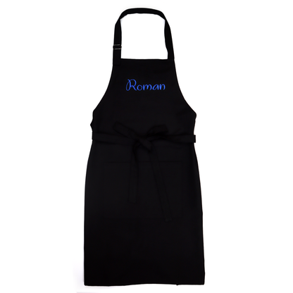 Personalized black apron on a white background, embroidered with the name "Roman" in blue script